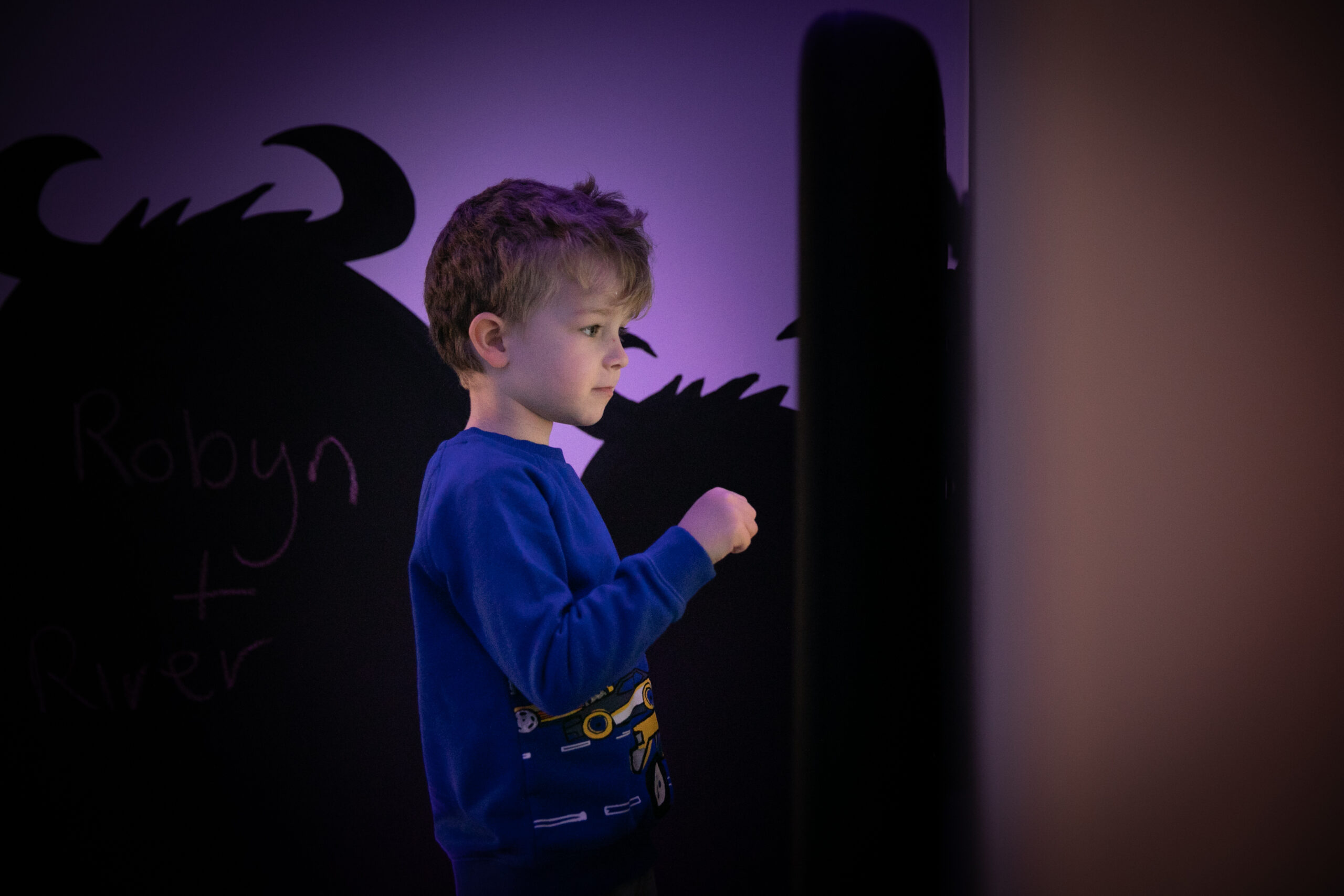 Wall-mounted touchscreen games panel at Small+Mighty